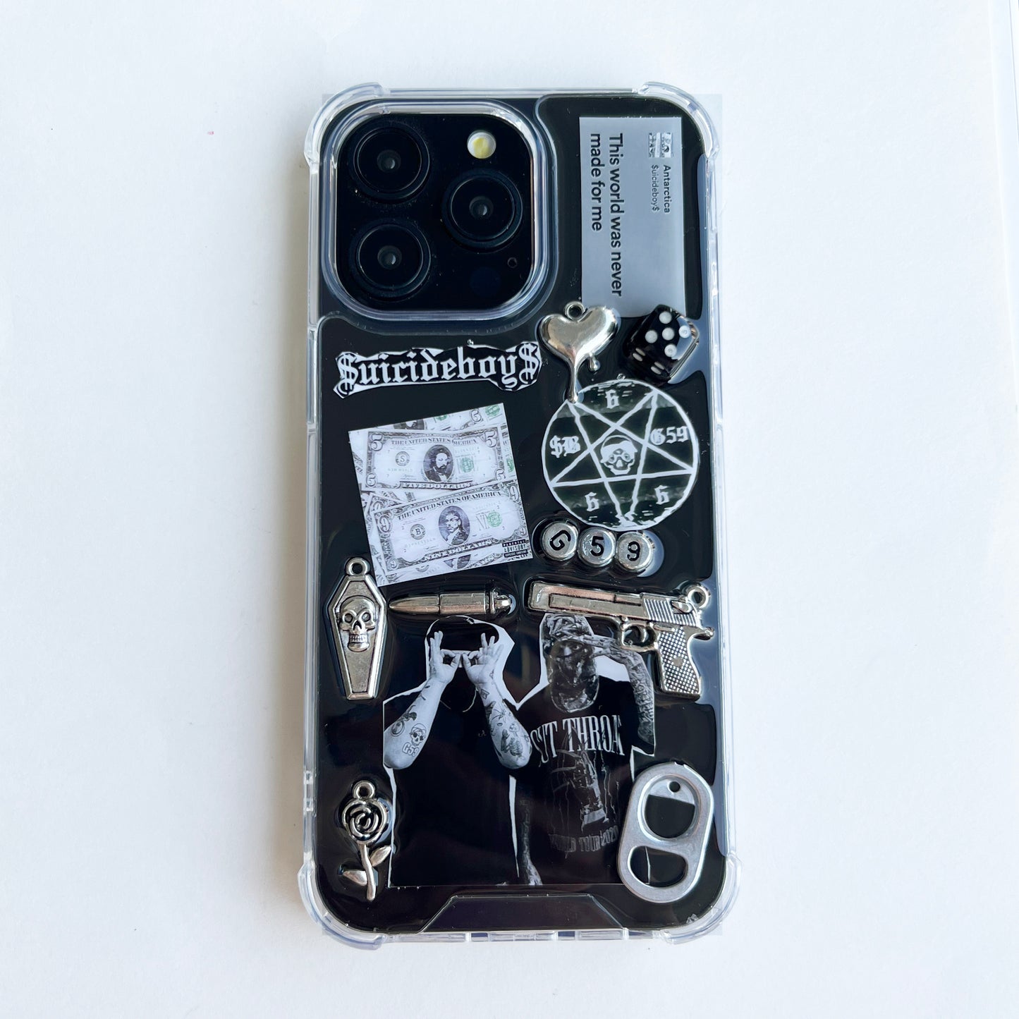 custom suicideboys $uicideboy$ Phone case decorated with Suicideboys band merchandise graphics, including a black-and-white graphic print, a pentagram, a skull, a revolver, a dollar bill, dice, and gothic text, shown on a plain white background.