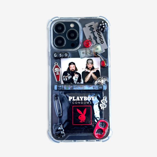 suicideboys phone case featuring a collage of heavy metal and rock-themed stickers and charms, including a 'Playboy Condoms' logo, a 'Tobacco' band sticker, a 'g59' graphic, and a photo of the band members, shown on a light white background.