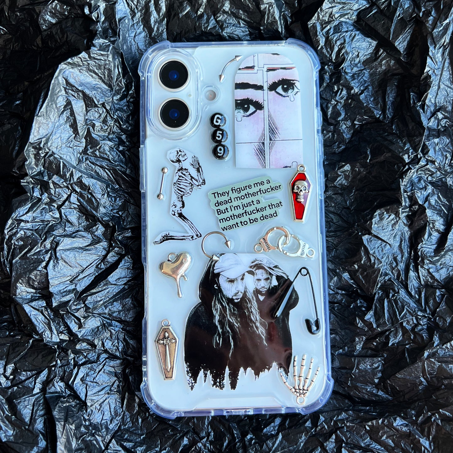 G59 suicideboys clear phone case with a gothic graphic collage design, featuring a skeleton, a face illustration, a coffin, a small red-and-white figure, and a quote card, shown on a black background.