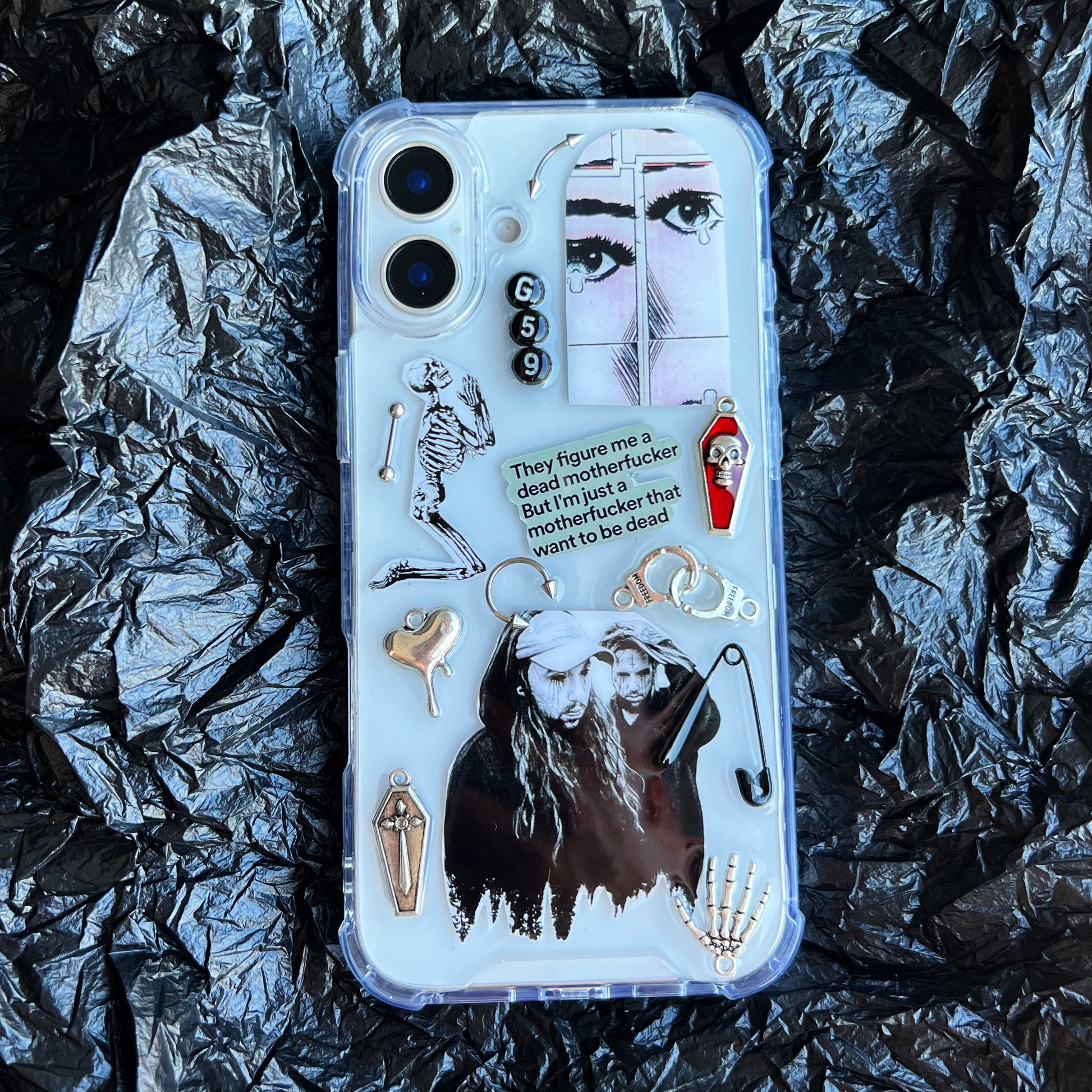 G59 suicideboys clear phone case with a gothic graphic collage design, featuring a skeleton, a face illustration, a coffin, a small red-and-white figure, and a quote card, shown on a black background.